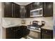 Contemporary kitchen boasting dark wood cabinetry, stainless steel appliances, and granite countertops at 3806 Sourwood Ct, Ladson, SC 29456