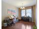This living room features a piano, natural light from two windows, and hardwood floors at 3806 Sourwood Ct, Ladson, SC 29456