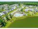 A stunning aerial view of a community showcasing beautiful homes, a pool, and a serene lake at 3870 Fifle St, Mount Pleasant, SC 29466