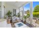 Relaxing covered outdoor porch with a modern fire pit and comfortable chairs and tables at 3870 Fifle St, Mount Pleasant, SC 29466