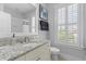 Well-lit bathroom with granite vanity, modern fixtures, and a shower-tub combo, providing a clean and functional space at 3870 Fifle St, Mount Pleasant, SC 29466