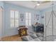 Bright bedroom with light blue walls, hardwood floor, and study area perfect for learning and play at 3870 Fifle St, Mount Pleasant, SC 29466