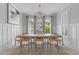 Bright dining room with modern chandelier, seating for eight, large painting, and three bright windows at 3870 Fifle St, Mount Pleasant, SC 29466