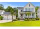 Charming two-story home with a spacious front porch and a detached garage featuring a basketball hoop at 3870 Fifle St, Mount Pleasant, SC 29466