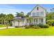 Attractive two-story home with a detached garage, palm trees, and a spacious front lawn at 3870 Fifle St, Mount Pleasant, SC 29466