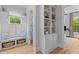 Bright hallway with a built-in window bench, storage baskets, and decorative shelving in a modern style at 3870 Fifle St, Mount Pleasant, SC 29466