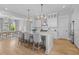Bright, open kitchen with a large island, white cabinets, and stainless steel appliances, flowing into dining area at 3870 Fifle St, Mount Pleasant, SC 29466