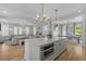 Bright, open kitchen with island, stainless steel appliances, and view of the living room and dining area at 3870 Fifle St, Mount Pleasant, SC 29466