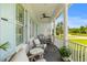 Relaxing front porch featuring comfortable seating, a porch swing, and charming decor at 3870 Fifle St, Mount Pleasant, SC 29466