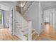 Elegant staircase with white banisters and hardwood steps, connecting the home's various levels at 3870 Fifle St, Mount Pleasant, SC 29466