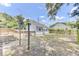 Expansive backyard featuring a detached garage, a wooden deck, and grassy lawn at 4756 Churchill Rd, North Charleston, SC 29405