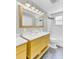 Bright bathroom featuring a double sink vanity, large mirror, and shower with tiled walls at 4756 Churchill Rd, North Charleston, SC 29405
