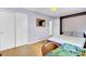 Bedroom with hardwood floors, a murphy bed and built-in shelves, and a decorative gold mirror at 4756 Churchill Rd, North Charleston, SC 29405