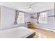 Well-lit bedroom with hardwood floors, neutral walls, and windows that provide ample natural light at 4756 Churchill Rd, North Charleston, SC 29405