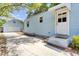 Charming blue house featuring a detached garage and ample parking space at 4756 Churchill Rd, North Charleston, SC 29405