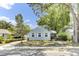 Charming light blue two-story home with landscaped yard, mature trees, and covered porch at 4756 Churchill Rd, North Charleston, SC 29405