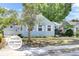 Charming light blue two-story home with landscaped yard, mature trees, and detached garage at 4756 Churchill Rd, North Charleston, SC 29405