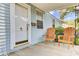 Charming front porch view featuring a white door with a palm tree detail and rocking chairs at 4756 Churchill Rd, North Charleston, SC 29405