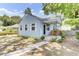 Cozy front porch with charming decor, including wood rocking chairs and detailed woodwork at 4756 Churchill Rd, North Charleston, SC 29405