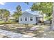 Charming light blue two-story home with landscaped yard, mature trees, and covered porch at 4756 Churchill Rd, North Charleston, SC 29405