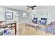 Open-concept living room features modern decor, hardwood floors, and blue accent chairs for added style at 4756 Churchill Rd, North Charleston, SC 29405