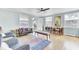 Inviting living room with an open door, bench seating, and a classic sofa, creating a comfortable living space at 4756 Churchill Rd, North Charleston, SC 29405