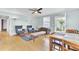 Cozy living room with natural light, hardwood floors, and a decorative ceiling fan creating a comfortable atmosphere at 4756 Churchill Rd, North Charleston, SC 29405