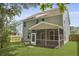 Spacious, green backyard featuring a screened-in porch, wood fence, and a well-kept lawn at 4949 Serene Ln, Hollywood, SC 29449