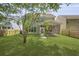Large backyard featuring a screened-in porch, lush green grass, and privacy fence at 4949 Serene Ln, Hollywood, SC 29449