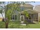 View of the backyard with a screened porch and well-maintained lawn at 4949 Serene Ln, Hollywood, SC 29449