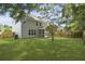 A spacious backyard with green lawn and a screened-in porch at 4949 Serene Ln, Hollywood, SC 29449