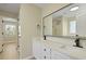 Bright bathroom featuring double sinks, black fixtures, and a large mirror reflecting the shower at 4949 Serene Ln, Hollywood, SC 29449