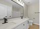 Bathroom features a double vanity with white cabinets, quartz counters, dark fixtures, and a modern toilet at 4949 Serene Ln, Hollywood, SC 29449