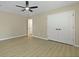 Bedroom features wood-look floors, a ceiling fan, and a closet with double doors at 4949 Serene Ln, Hollywood, SC 29449