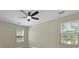 Bedroom featuring a modern ceiling fan, two windows, and tan walls at 4949 Serene Ln, Hollywood, SC 29449