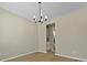 Elegant dining room featuring hardwood floors and a stylish chandelier, adjacent to the kitchen at 4949 Serene Ln, Hollywood, SC 29449