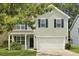 Charming two-story home with light green siding, black shutters, and a well-manicured lawn at 4949 Serene Ln, Hollywood, SC 29449
