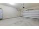 Spacious two-car garage with concrete floor, white walls, and an insulated door at 4949 Serene Ln, Hollywood, SC 29449