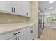 Kitchen boasts white cabinets and countertops with stainless steel appliances at 4949 Serene Ln, Hollywood, SC 29449