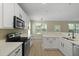 Open kitchen with stainless steel appliances and white cabinets at 4949 Serene Ln, Hollywood, SC 29449