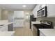 Kitchen features stainless steel appliances, white cabinets, and quartz countertops at 4949 Serene Ln, Hollywood, SC 29449