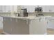 Eat-in kitchen island with white cabinets, modern faucet and quartz countertops at 4949 Serene Ln, Hollywood, SC 29449