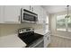 Kitchen features stainless steel microwave, range and quartz countertops at 4949 Serene Ln, Hollywood, SC 29449