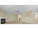 Bright living area with fireplace, ceiling fan, hardwood floors, and staircase access at 4949 Serene Ln, Hollywood, SC 29449