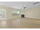 Spacious living room featuring a cozy fireplace, large windows, and elegant hardwood floors at 4949 Serene Ln, Hollywood, SC 29449