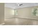 Main bedroom with a tray ceiling, ceiling fan, and two large windows at 4949 Serene Ln, Hollywood, SC 29449