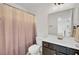 Well-lit bathroom featuring neutral-toned shower curtain, vanity, and essential fixtures at 613 Ravens Wood Rd, Summerville, SC 29486