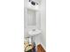 Bathroom showcasing a pedestal sink with wood floors and a white frame mirror at 613 Ravens Wood Rd, Summerville, SC 29486
