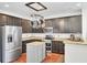 Stylish kitchen with stainless steel appliances, dark cabinets, and center island at 613 Ravens Wood Rd, Summerville, SC 29486