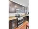 Modern kitchen with stainless steel appliances and dark wood cabinets at 613 Ravens Wood Rd, Summerville, SC 29486